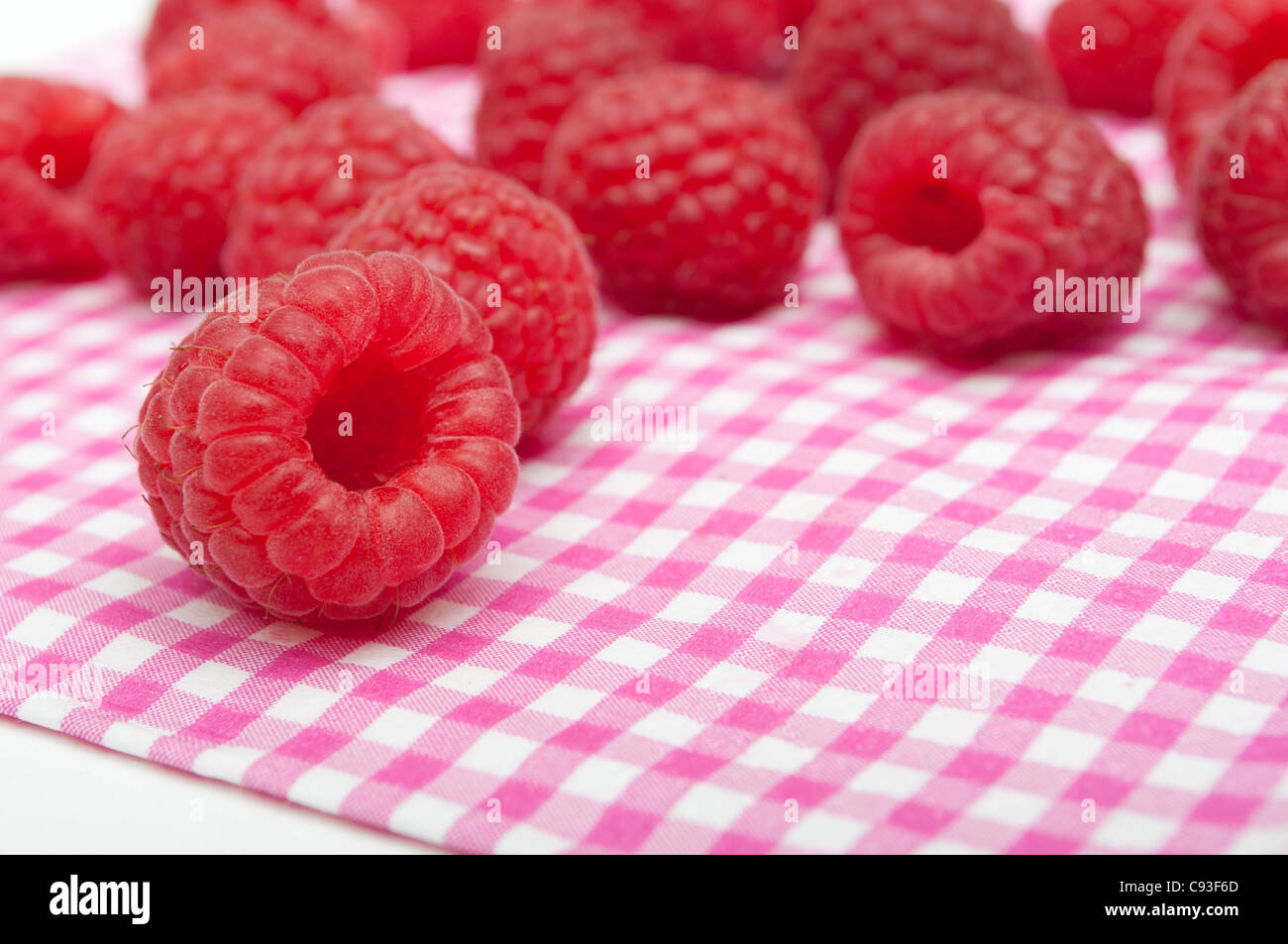 Fresh Raspberries on Pink Gingham Tablecloth Stock Photo