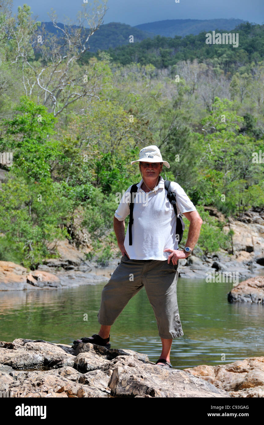 Male Tourist standing in front of rock pool on Alligator Creek, Bowling Green Bay National Park, Townsville, Queensland, Australia Stock Photo