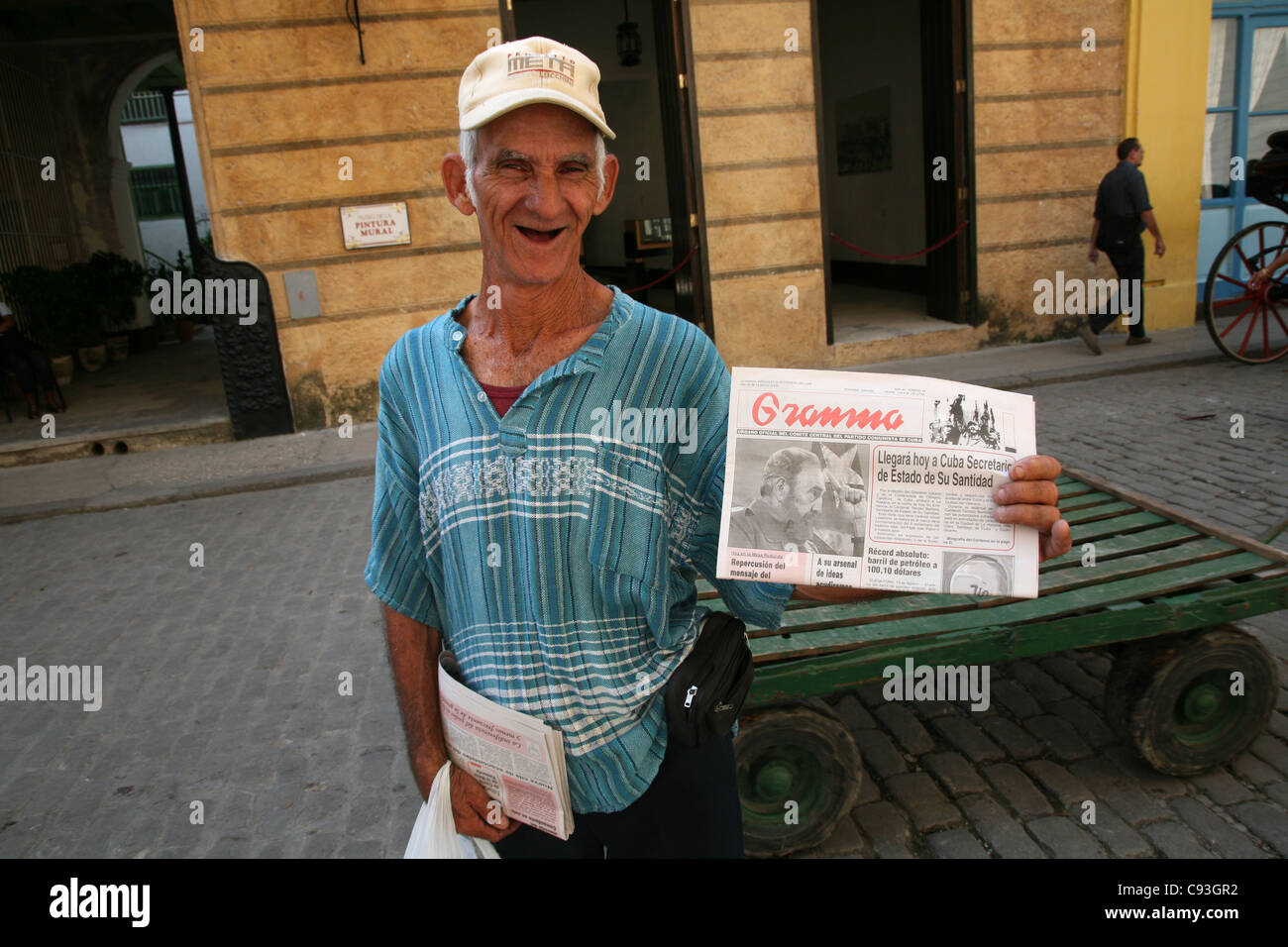 Cuban newsvendor sales the Granma newspaper in Havana, Cuba. Stock Photo