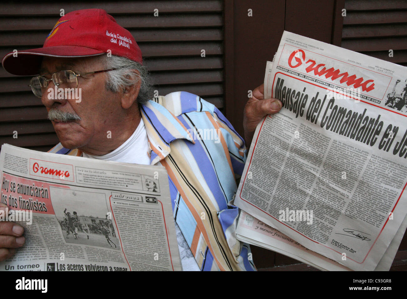 Cuban newsvendor sales the Granma newspaper with the official announcement of Fidel Castro's resignation in Havana, Cuba. Stock Photo