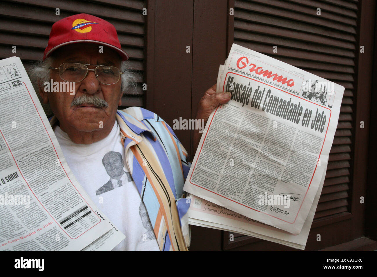 Cuban newsvendor sales the Granma newspaper with the official announcement of Fidel Castro's resignation in Havana, Cuba. Stock Photo