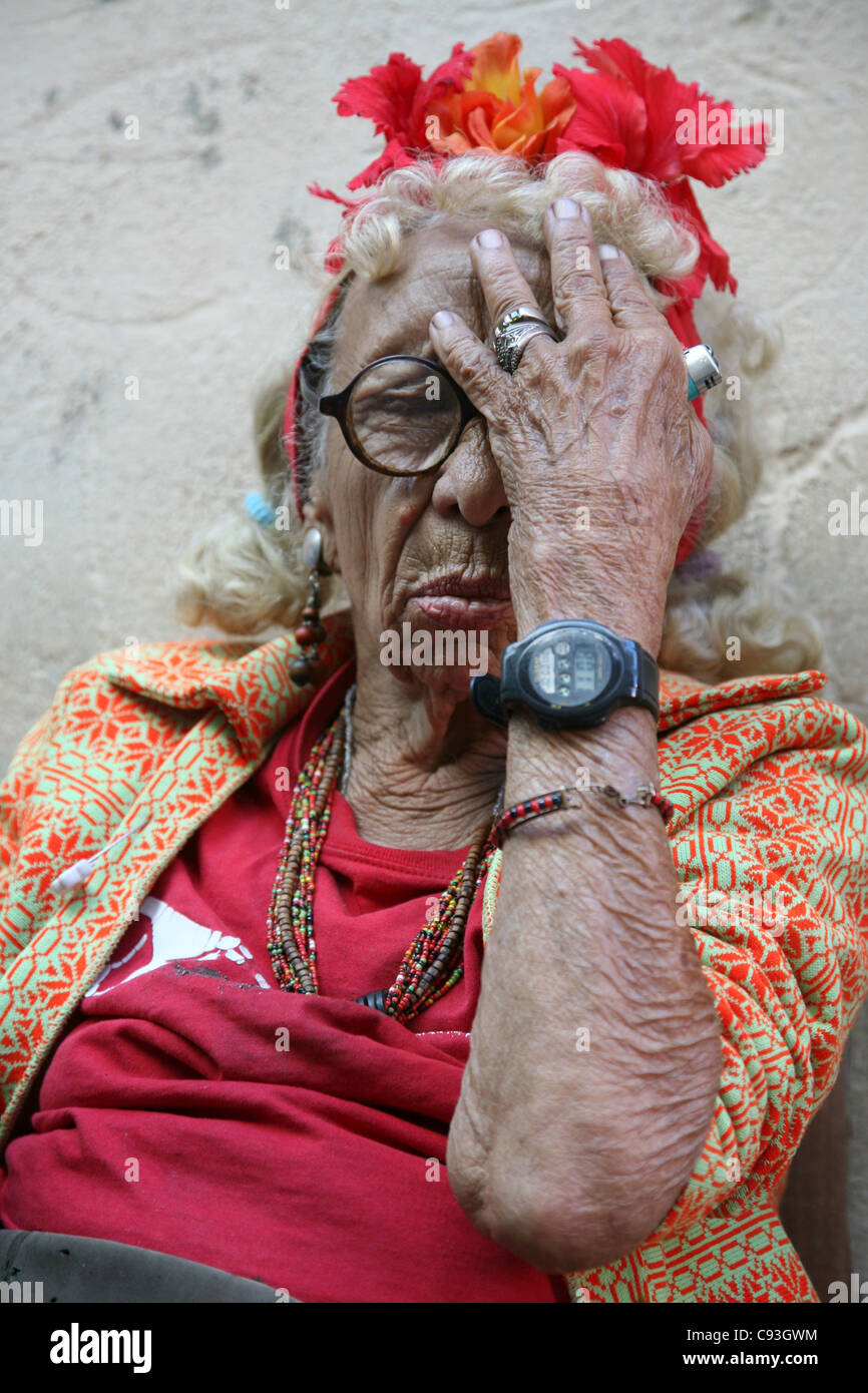 Eccentric elderly Cuban woman Graciela Gonzalez also known as Granny Puretta makes face palm at age 84 in the historical centre in Havana, Cuba. Stock Photo
