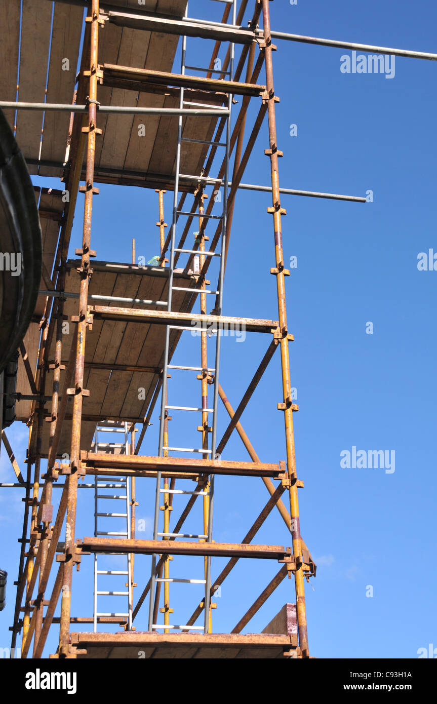 looking up a constructed scaffolding, with ladders and planks of wood. Stock Photo