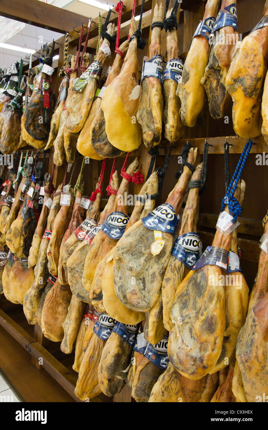 Hams Spanish Jamon hanging to displayed in supermarket store Spain