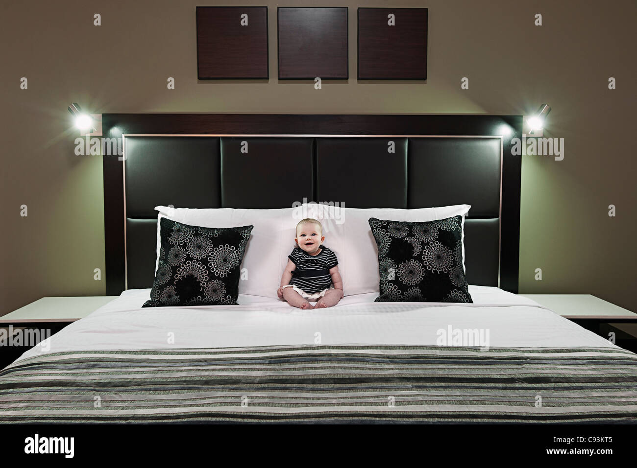 Baby sitting on bed hi-res stock photography and images - Alamy