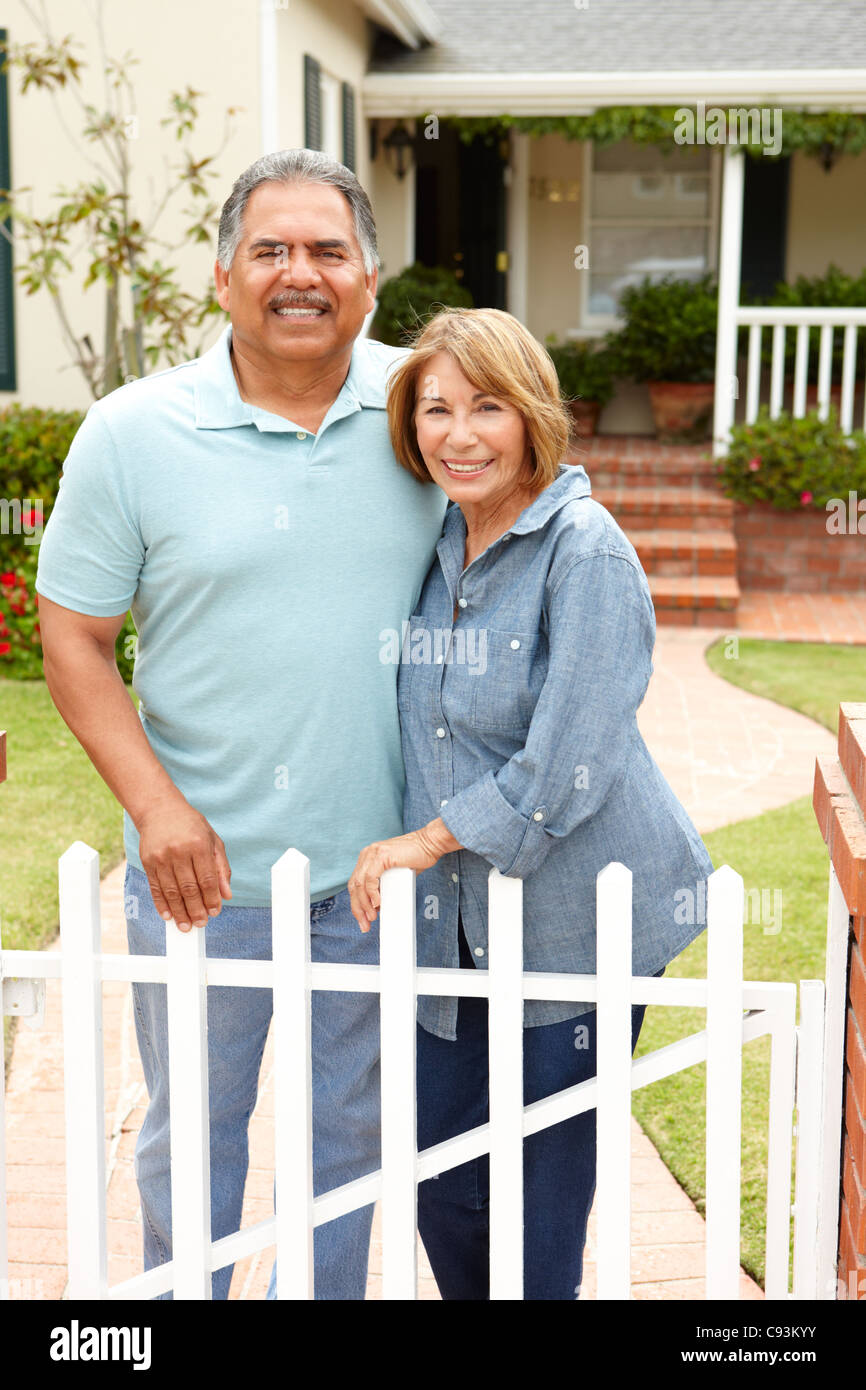 Senior Hispanic couple outside home Stock Photo