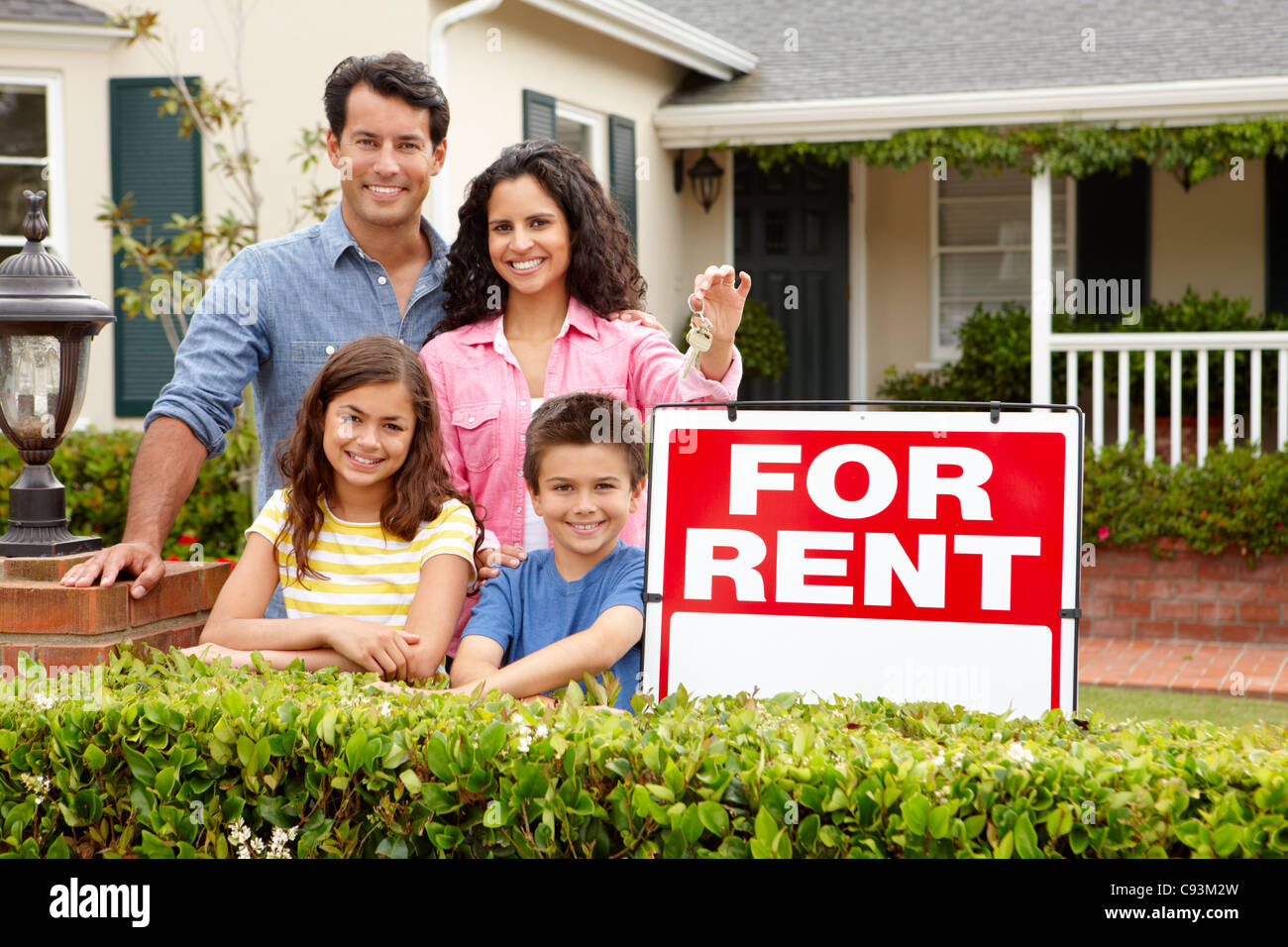 Hispanic family outside home for rent Stock Photo - Alamy