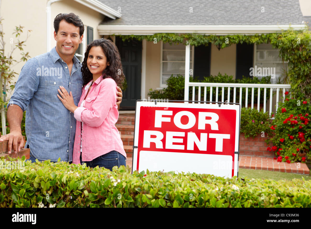 Hispanic couple outside home for rent Stock Photo
