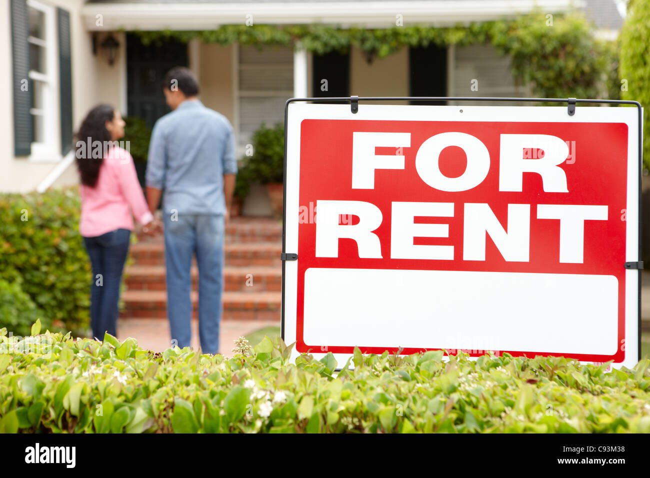 Hispanic couple outside home for rent Stock Photo - Alamy