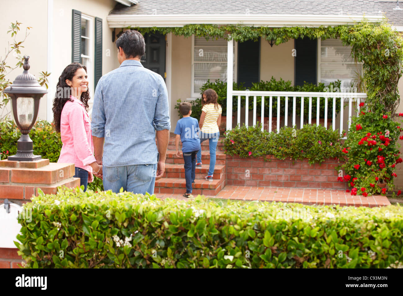 Hispanic family outside home for rent Stock Photo - Alamy