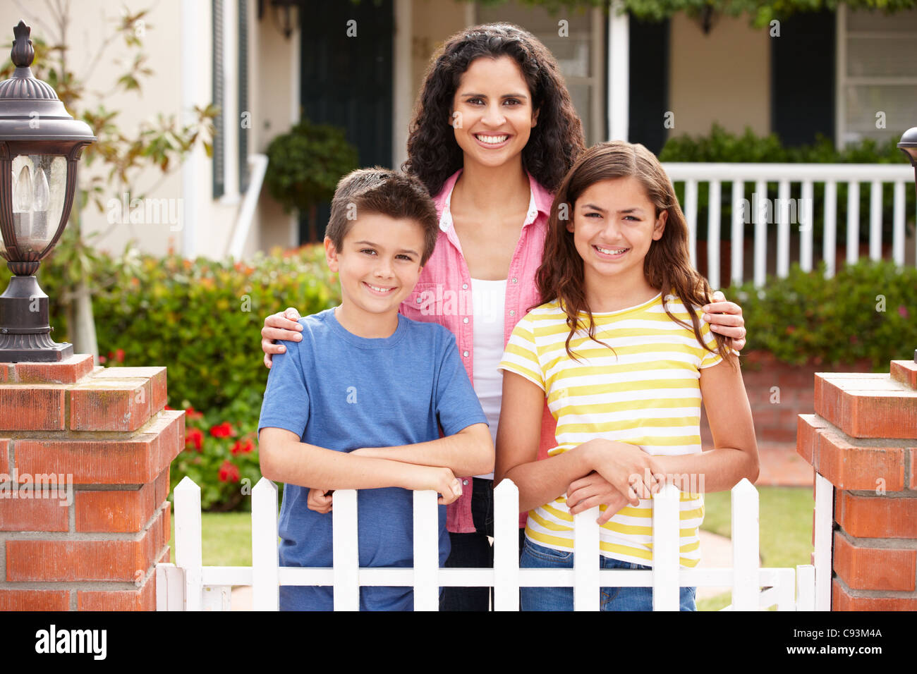 Mother and children outside home Stock Photo Alamy