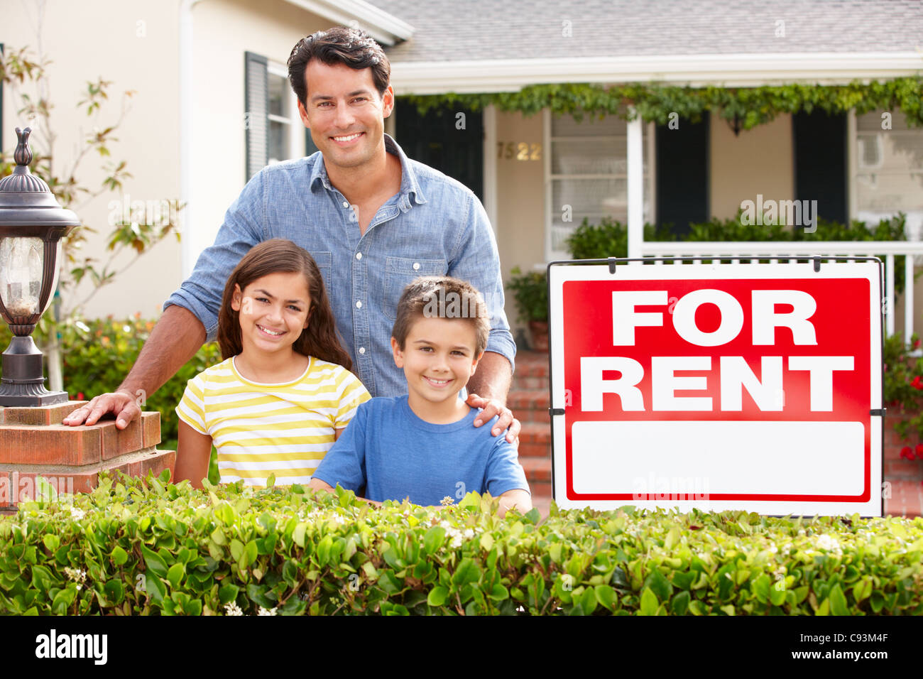 Father and children outside home for rent Stock Photo