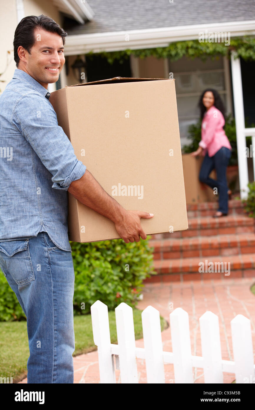 Hispanic couple moving into new house Stock Photo
