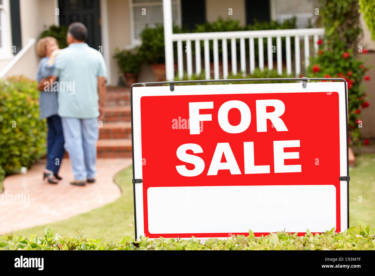 Senior Hispanic couple moving into new home Stock Photo - Alamy