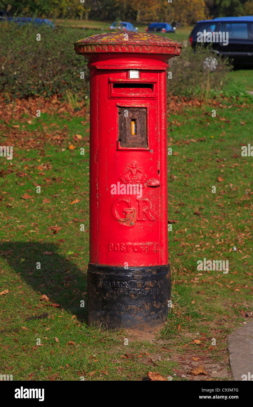Red pillarbox in a rural location. Post boxes from the early years of