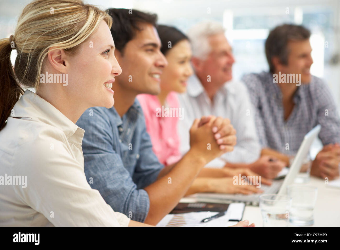 Mixed group in business meeting Stock Photo Alamy