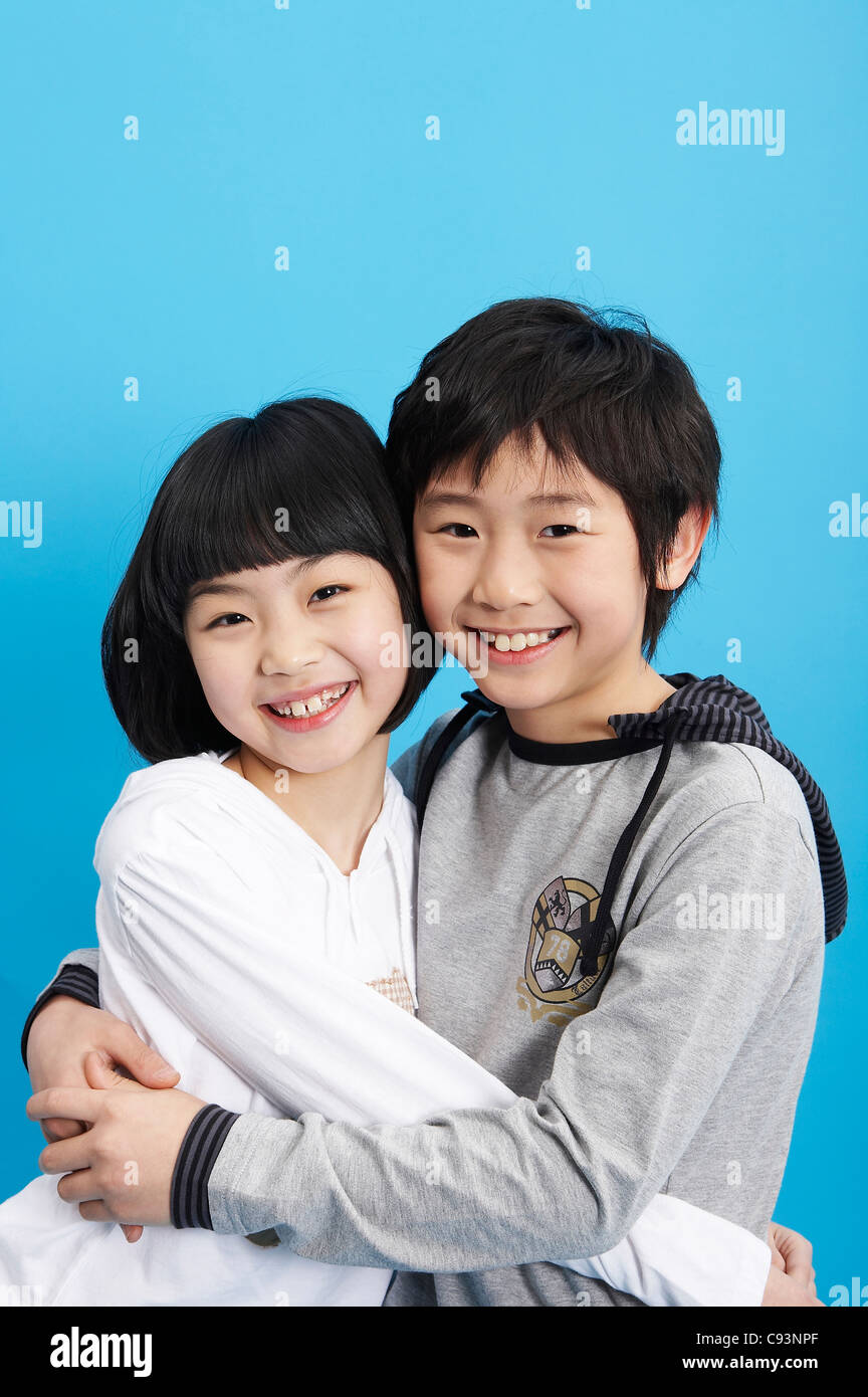Young boy and girl hugging each other, smiling Stock Photo - Alamy