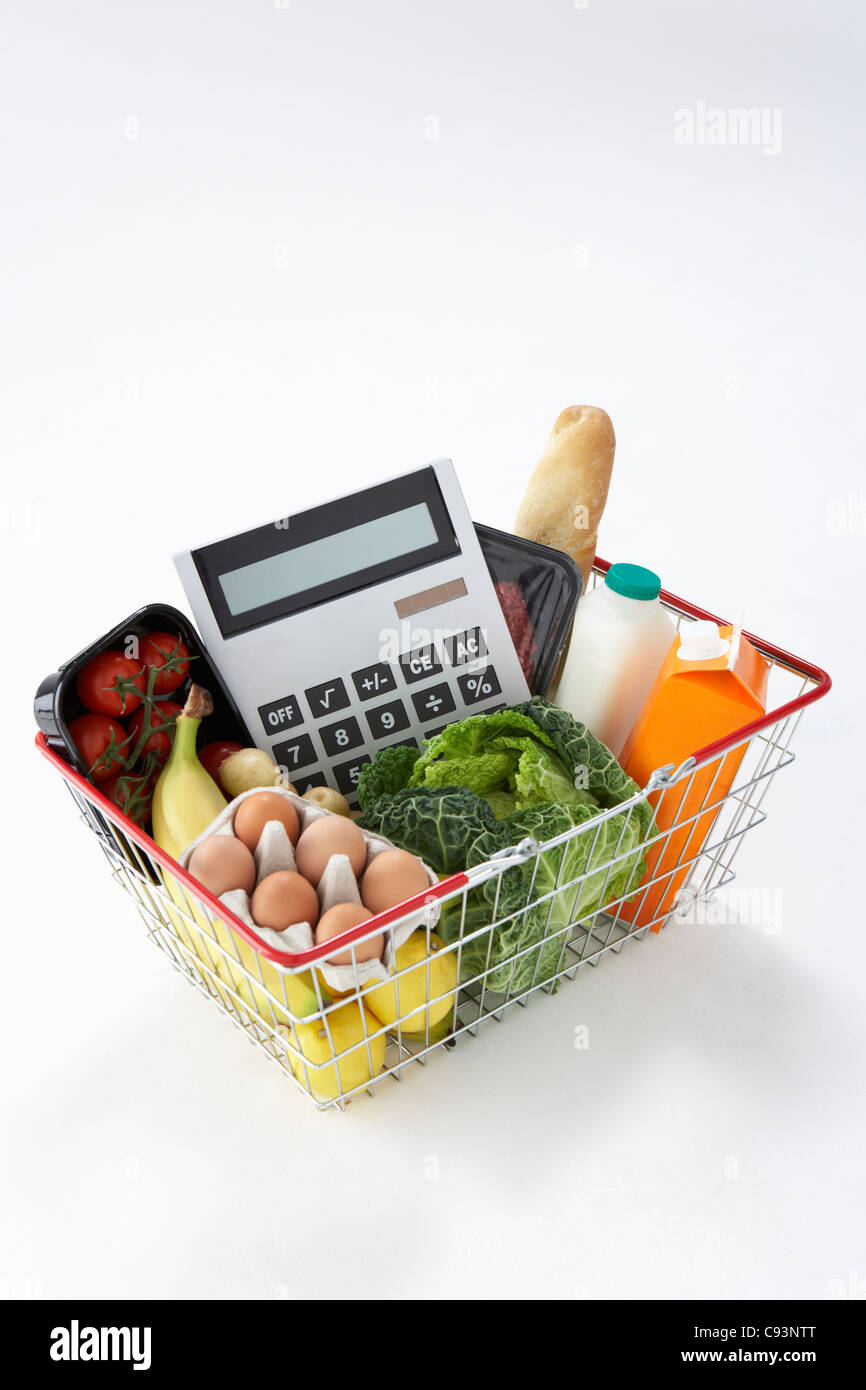 Basket of groceries and calculator Stock Photo