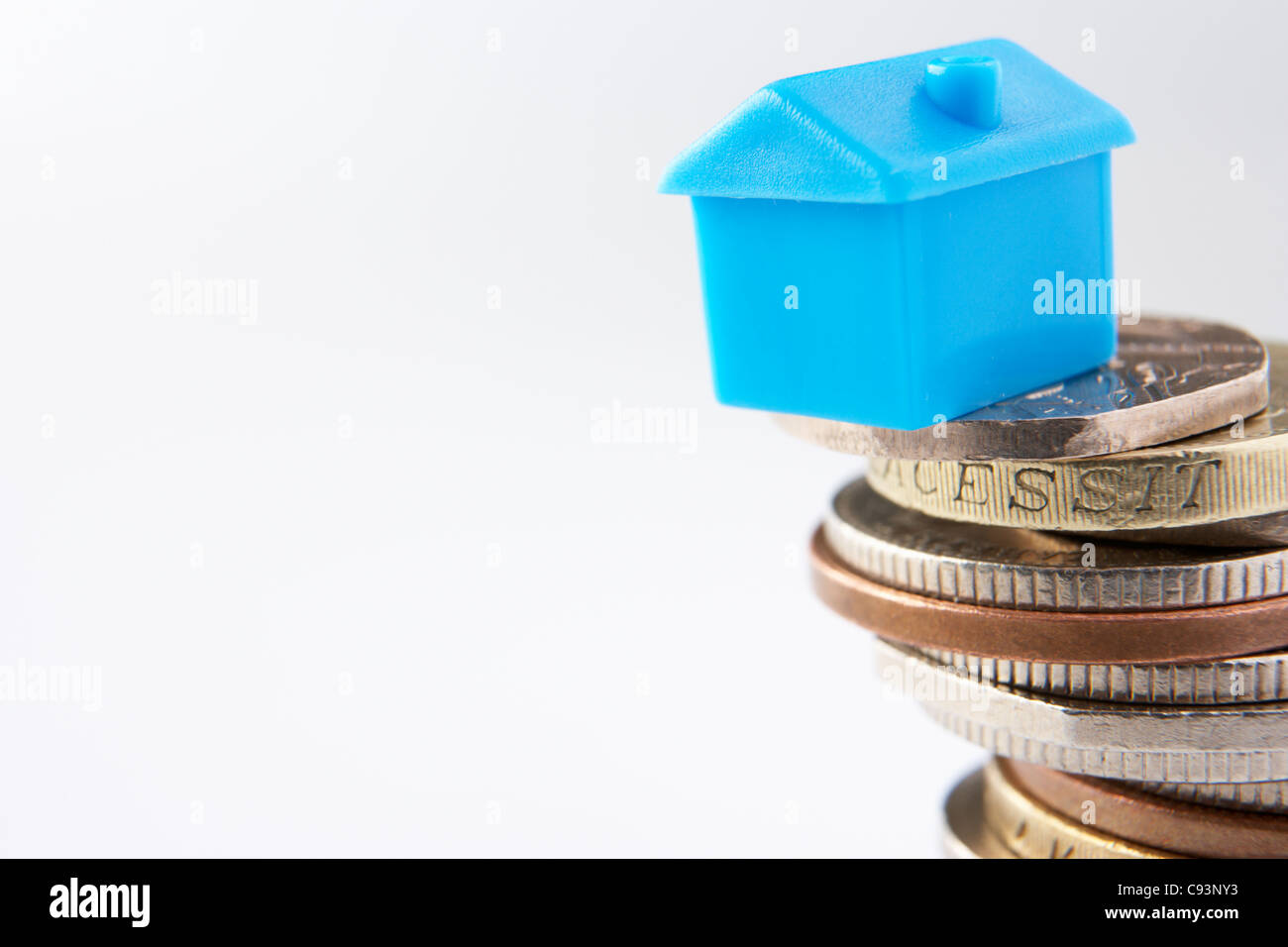 Small model house and coins Stock Photo