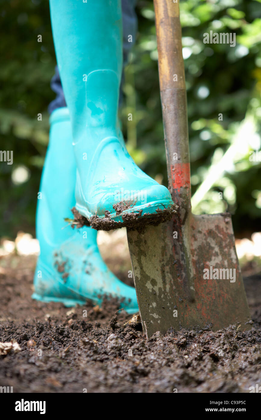 Person digging in garden Stock Photo