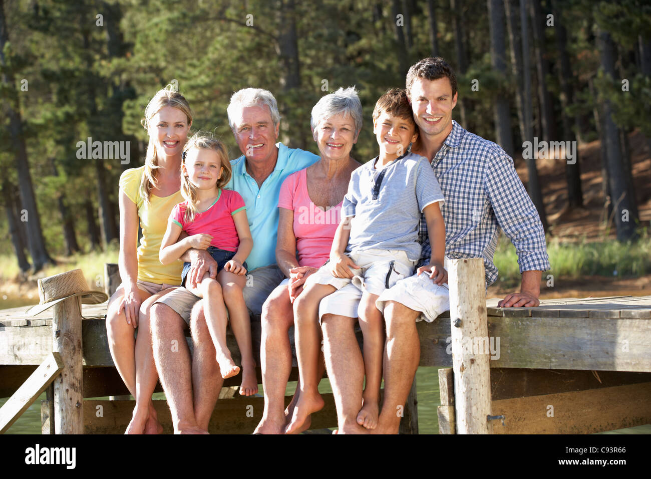 3 Generation family, sitting by lake Stock Photo