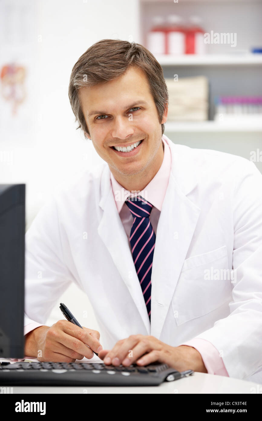 Hospital doctor at desk Stock Photo - Alamy