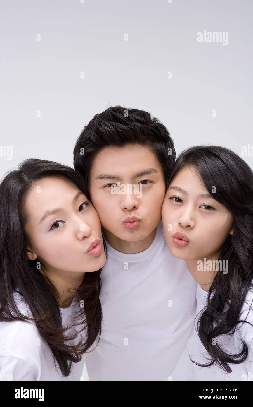 Three friends with kissing expression on face, portrait Stock Photo