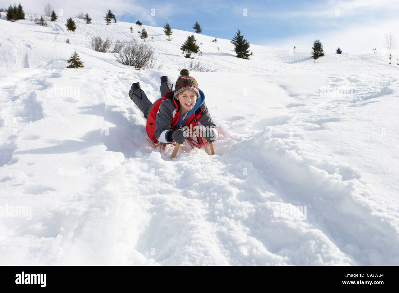 Pre Teen Boy On A Sled In The Snow Pre Teen Boy On A Sled In The Snow