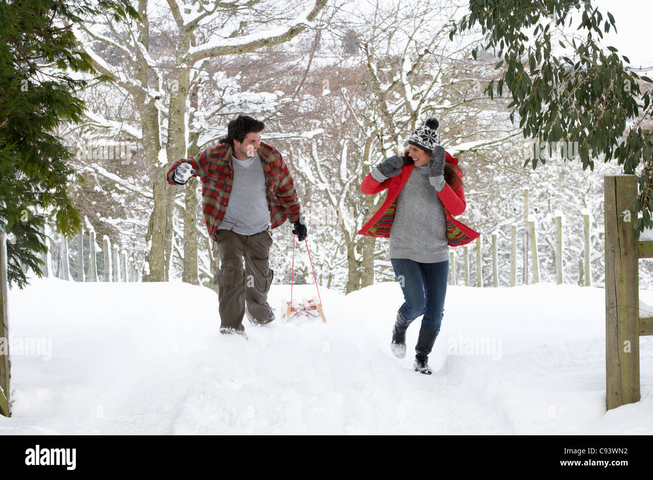 Young couple having snowball fight Stock Photo