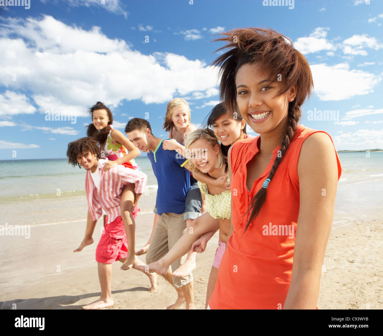 Teenagers walking on beach Stock Photo