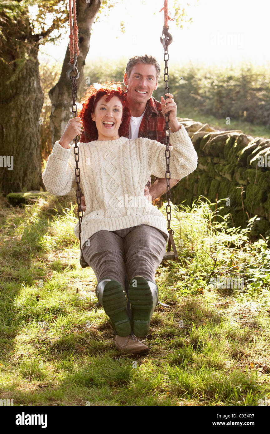 Couple with country garden swing Stock Photo