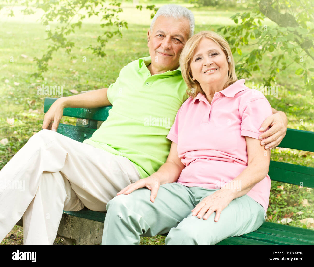 Happy senior couple relaxed on the park bench Stock Photo - Alamy