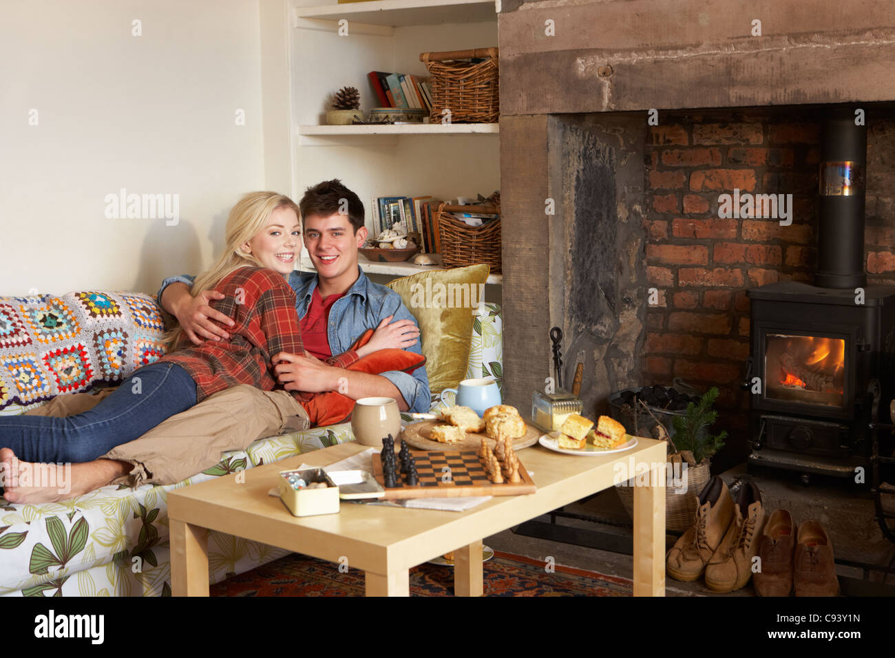 Young couple relaxing by fire Stock Photo