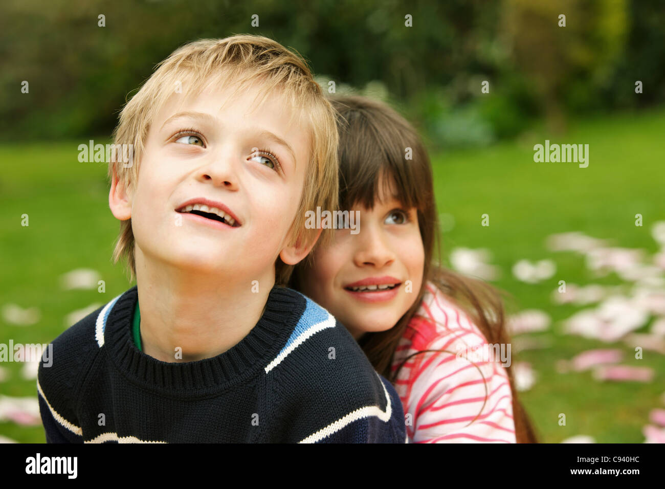 Young Girl Hugging Boy from behind Outdoors Stock Photo Alamy