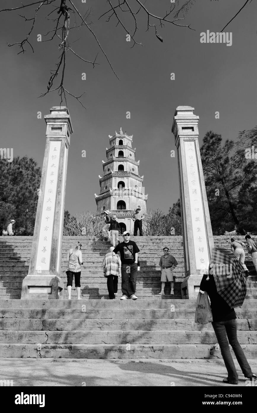 Asia, Vietnam, Hue. Tourists at the Thap Phuoc Duyen (Source of Happiness Tower) at Thien Mu (Heavenly Lady Pagoda). Designat... Stock Photo