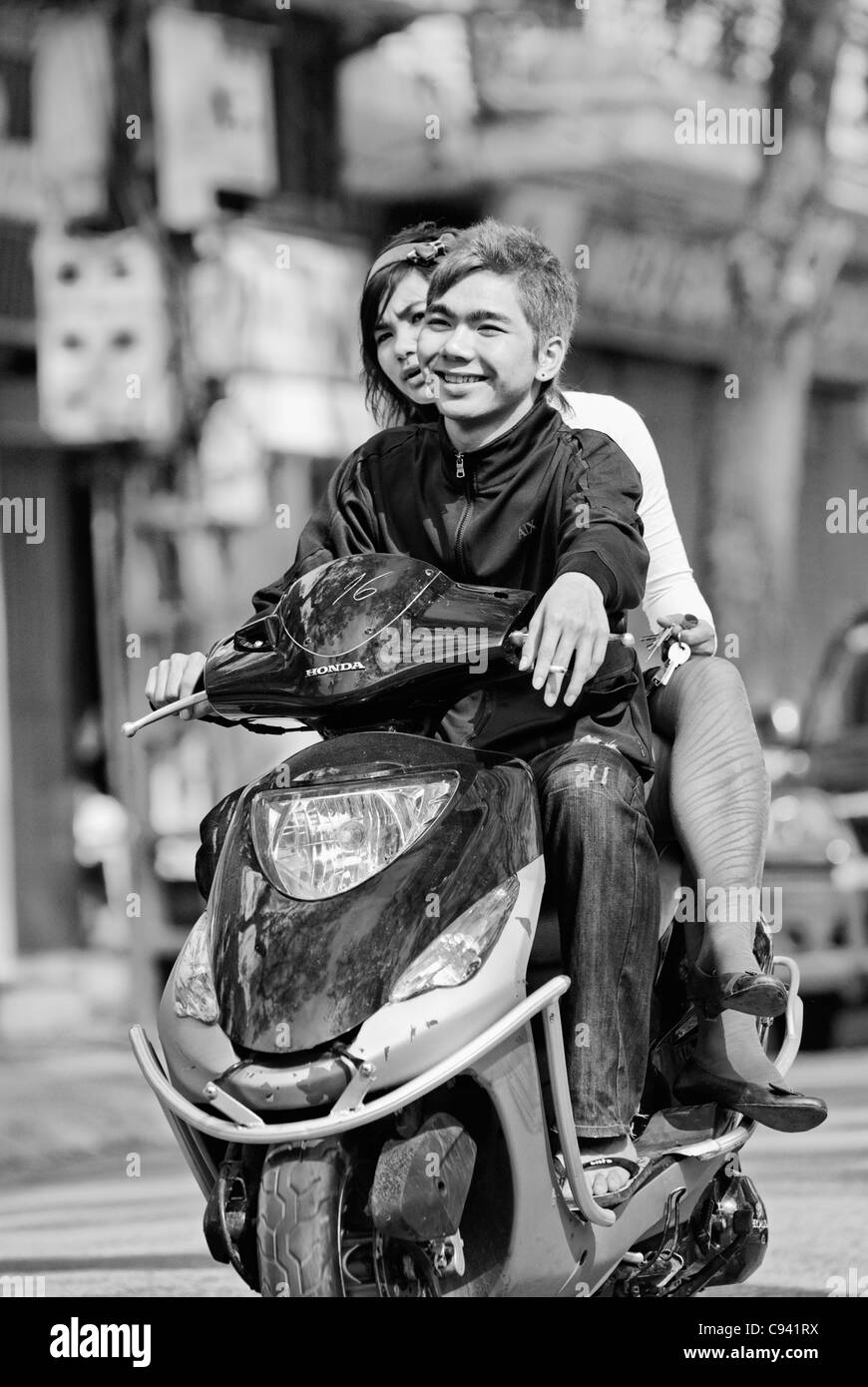 Asia, Vietnam, Hanoi. Hanoi old quarter. Cool vietnamese couple riding on a motorbike through Hanoi. Stock Photo