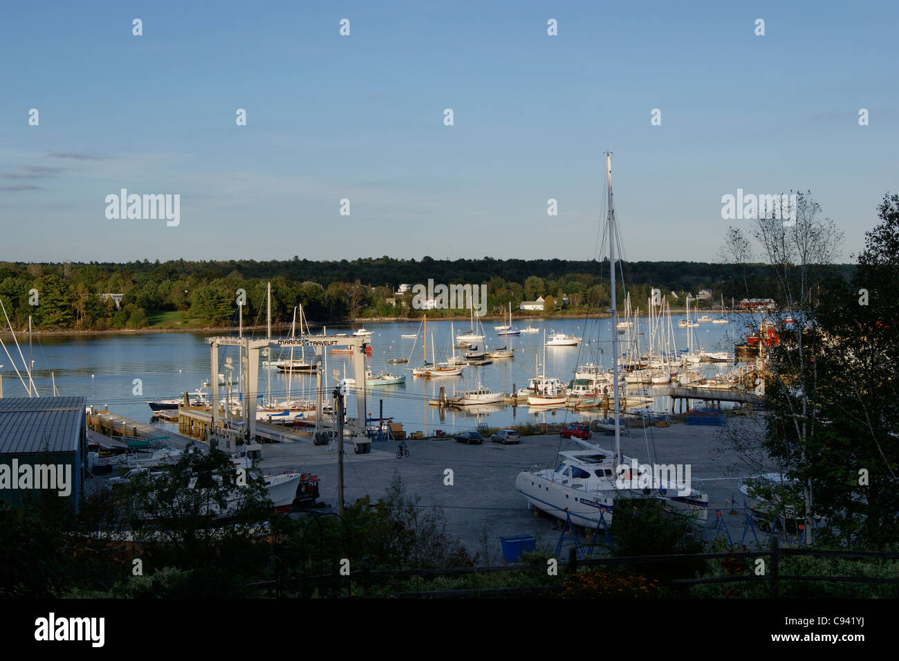 High-angle view of the Front Street Ship yard with boats at sunset on the Passagassawakeag River in Belfast, Maine. Stock Photo