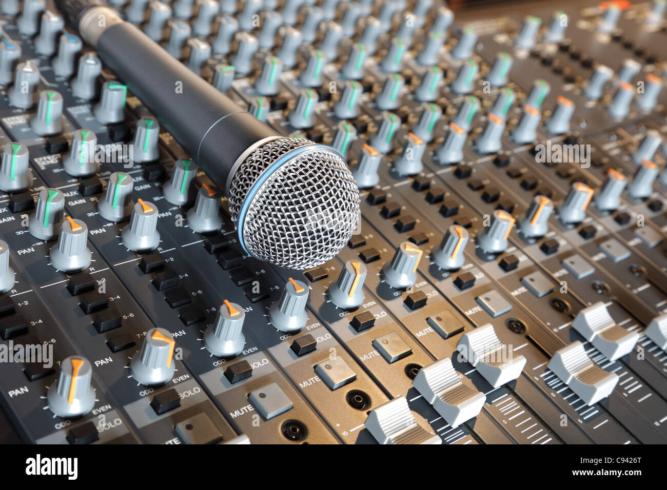 Microphone on an  audio mixing desk Stock Photo