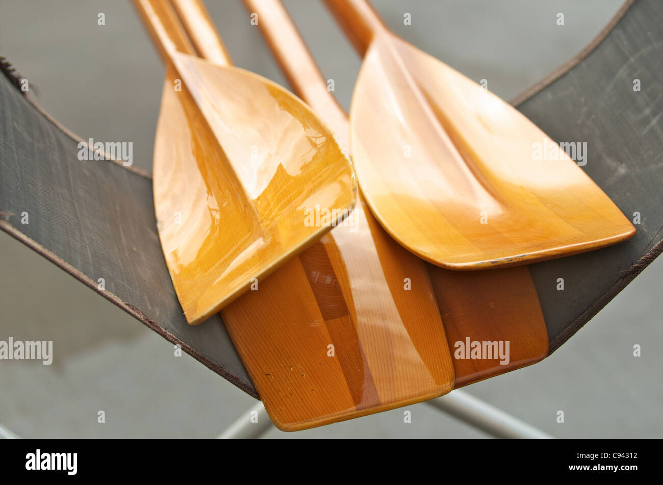 Detail of  wooden boat oars on a dock at a lake. Stock Photo