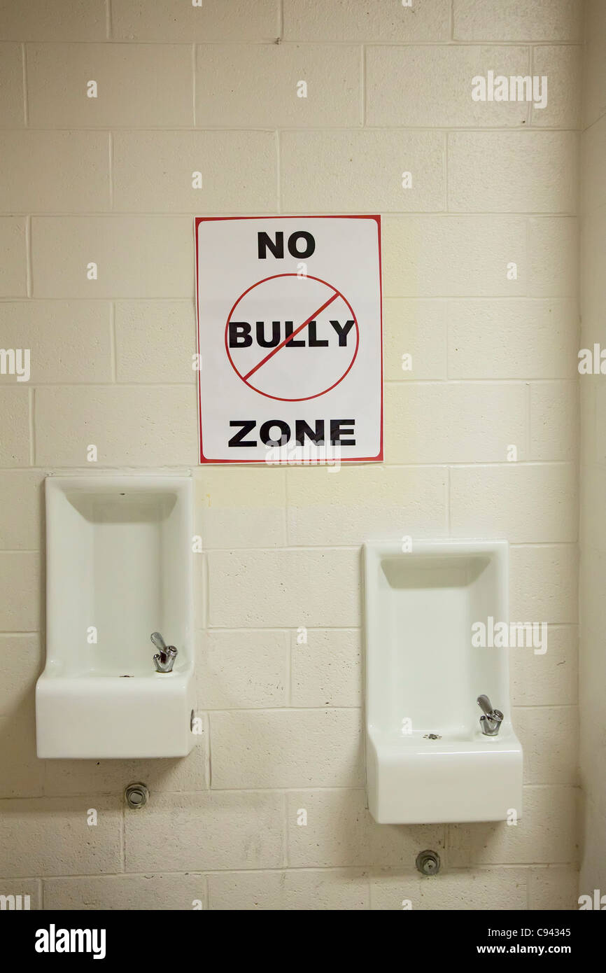 'No Bully Zone' sign in hallway at school Stock Photo