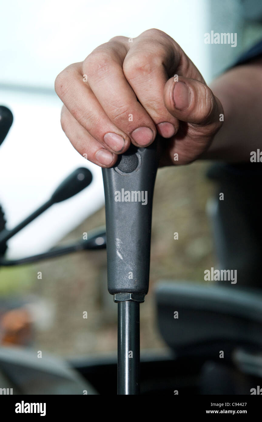 Tractor driver operating loader joystick control Stock Photo Alamy
