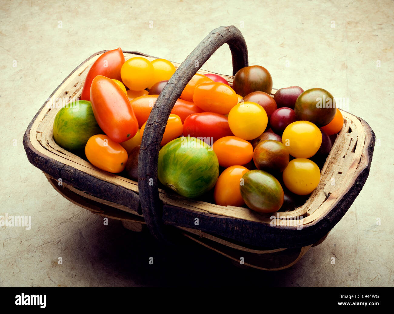 trug of small heritage tomatoes Stock Photo