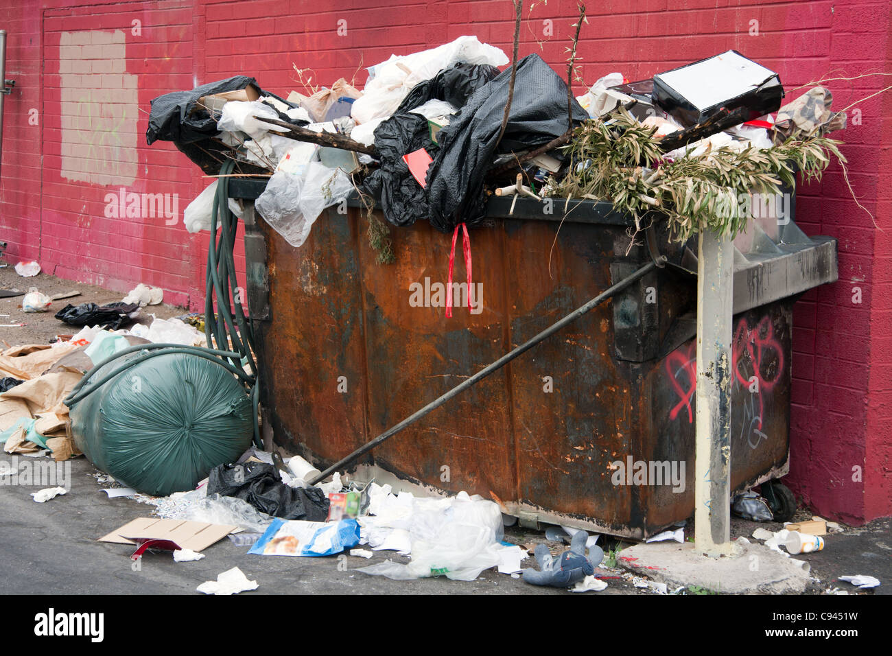 trash dumpster over filled Stock Photo Alamy