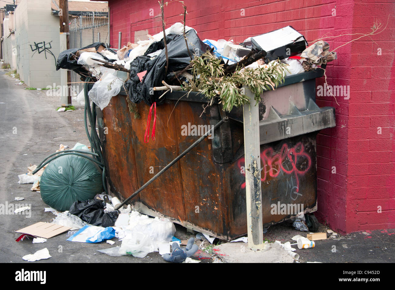 trash dumpster in alley Stock Photo