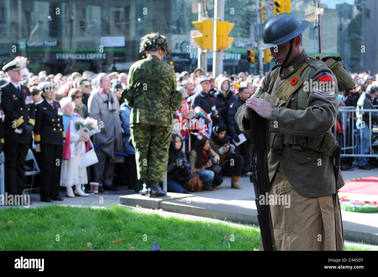 Two silent sentries on solemn guard amidst Torontonians during the Remembrance Day ceremony at Old City Hall in Toronto, Ontario, Canada, November 11, 2011. Stock Photo