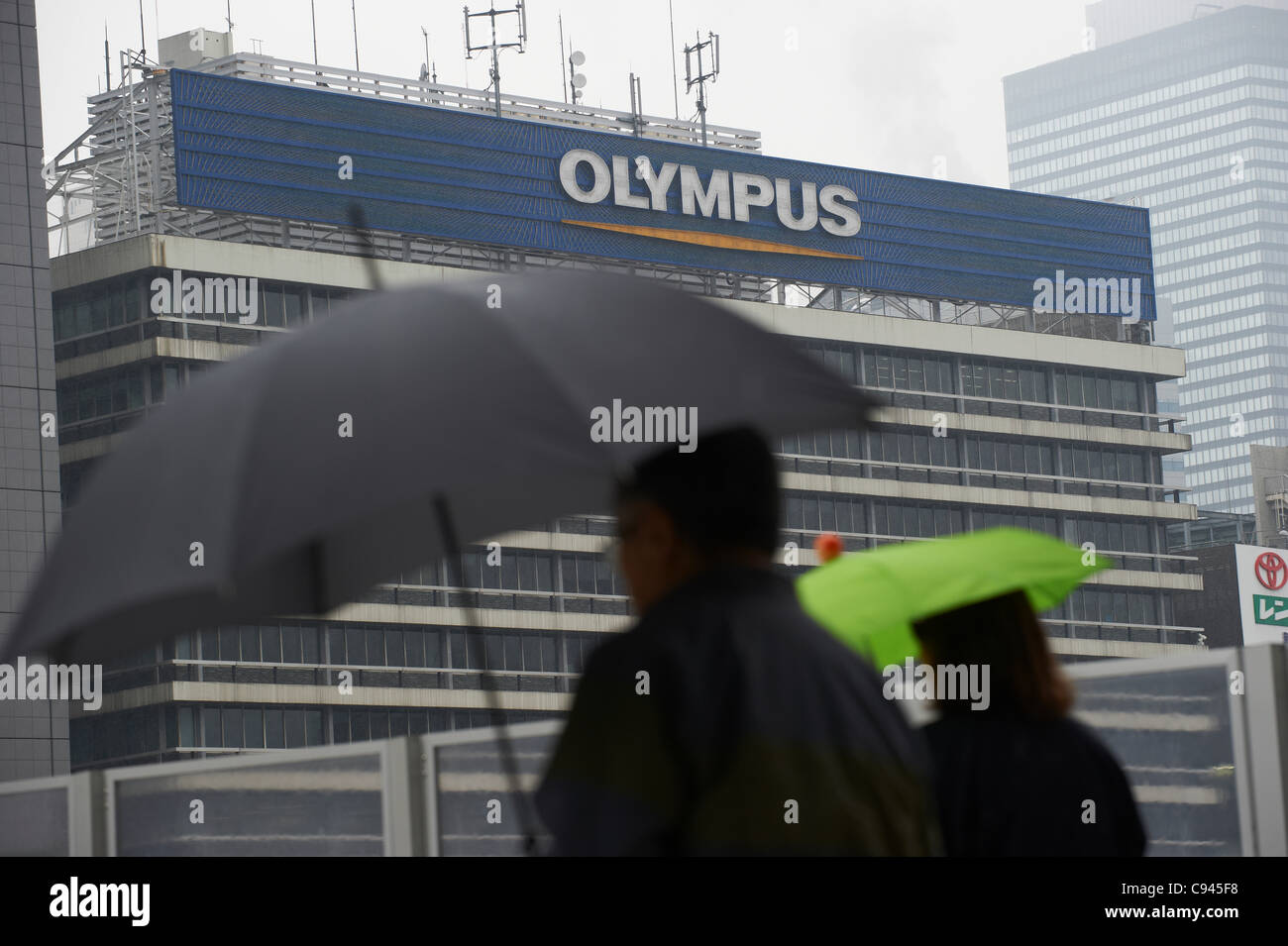 November 11 11 Tokyo Japan Against The Backdrop Of Olympus Billboard Pedestrians Scurry By In The Cold Mid Autumn Rain In Tokyos Shinjuku On Friday November 11 11 As Is The Weather