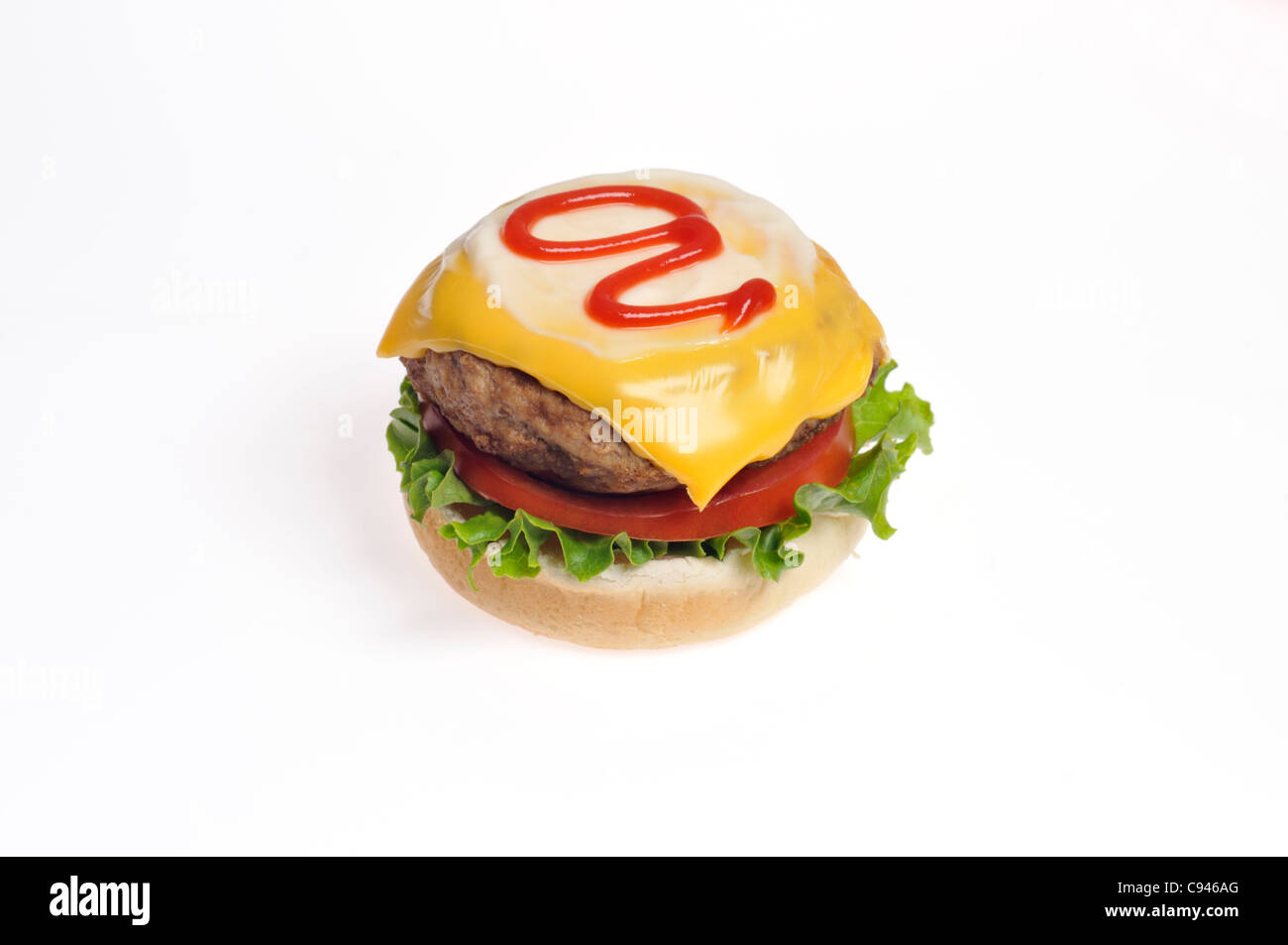 Turkey burger with cheese, lettuce and tomato topped with ketchup open faced on a bread roll on white background cutout. Stock Photo