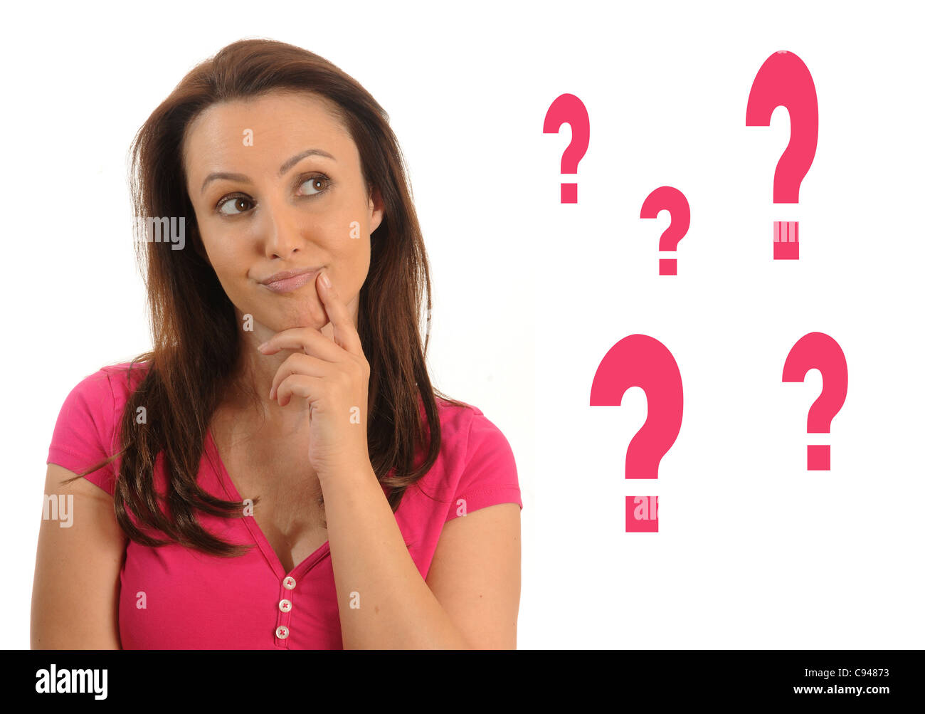 Thoughtful woman looking at some question marks. Stock Photo