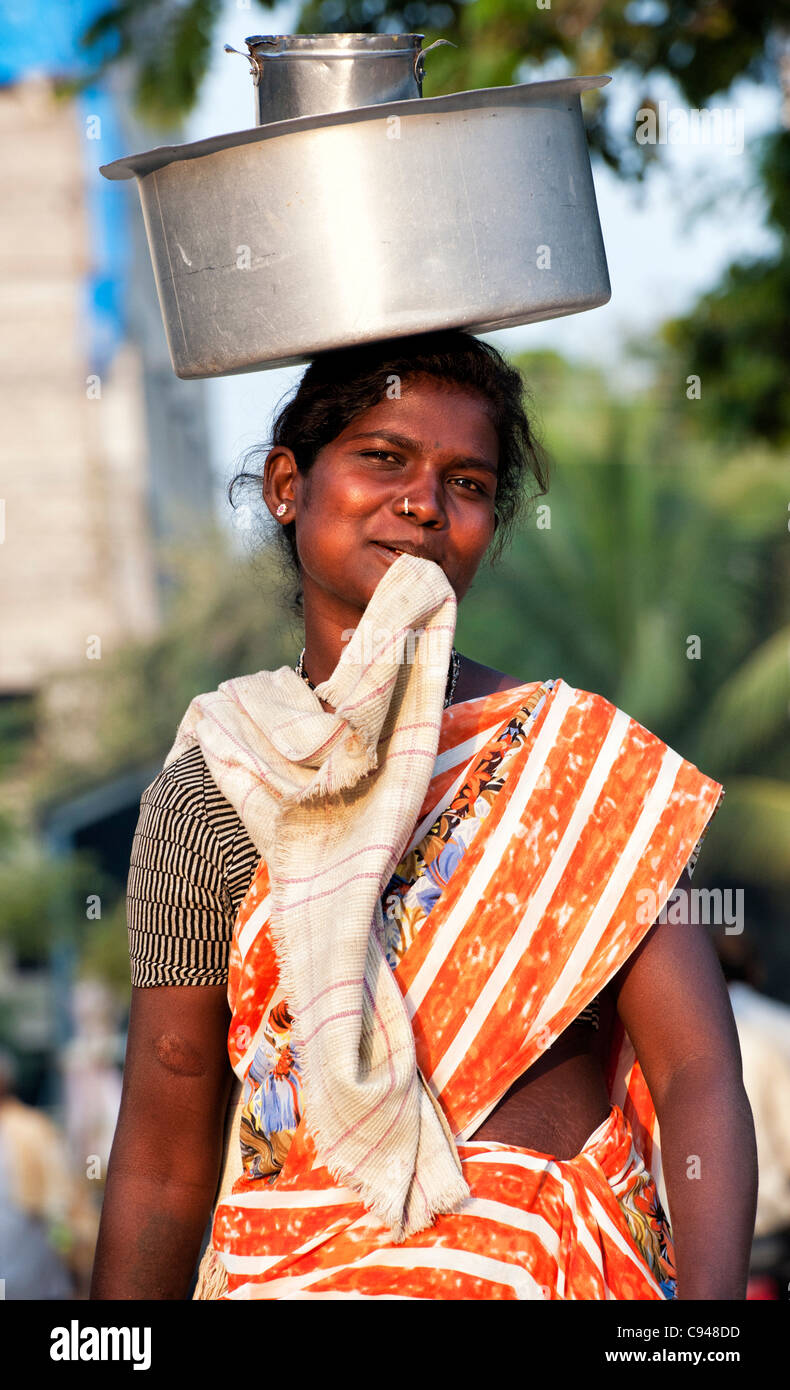 Lower caste indian women a carrying pot of rice on her head. Andhra ...