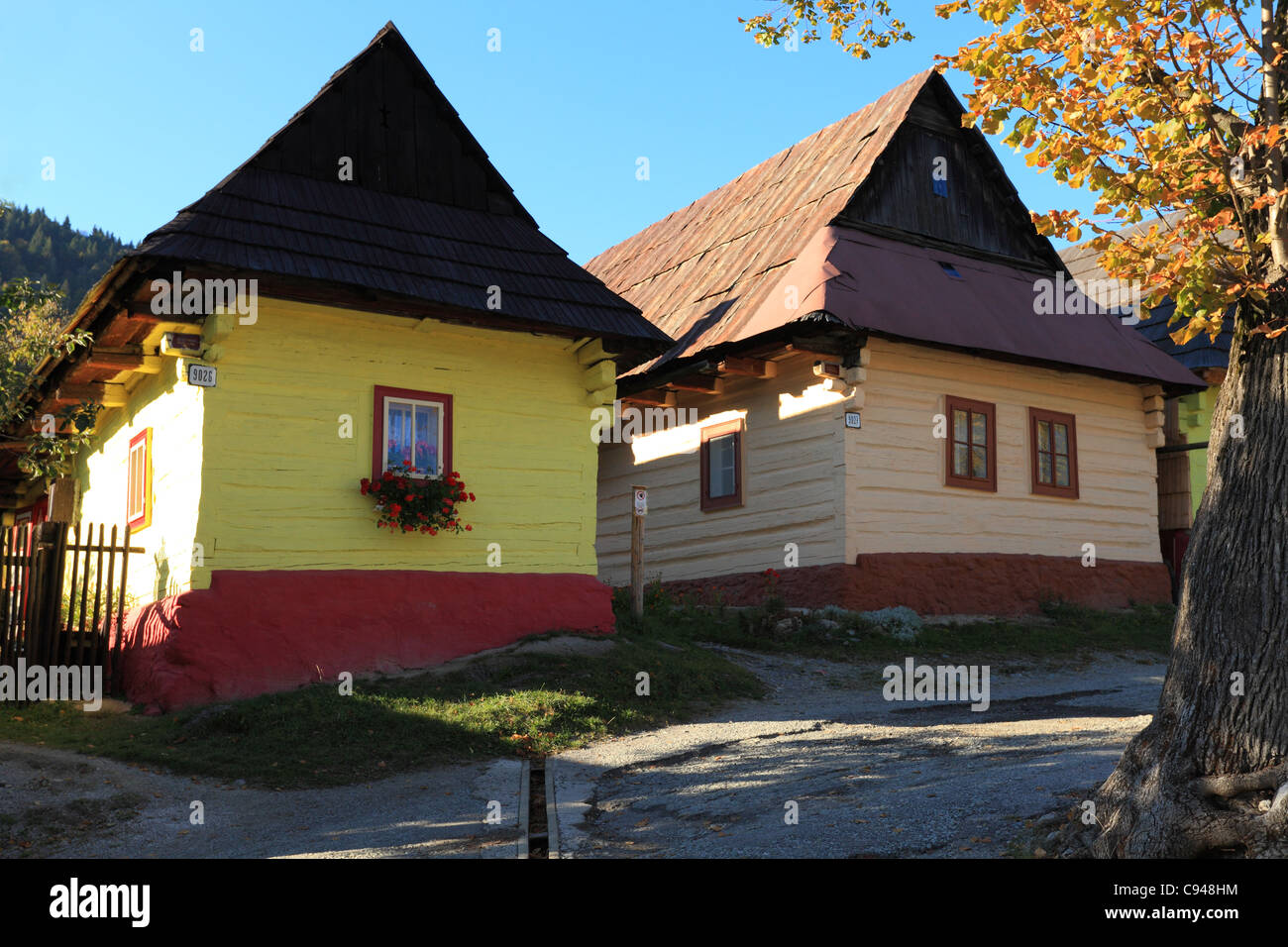 Traditional painted wooden cottages in Vlkolinec, Slovakia. Village is registered on UNESCO World Heritage Site list. Stock Photo